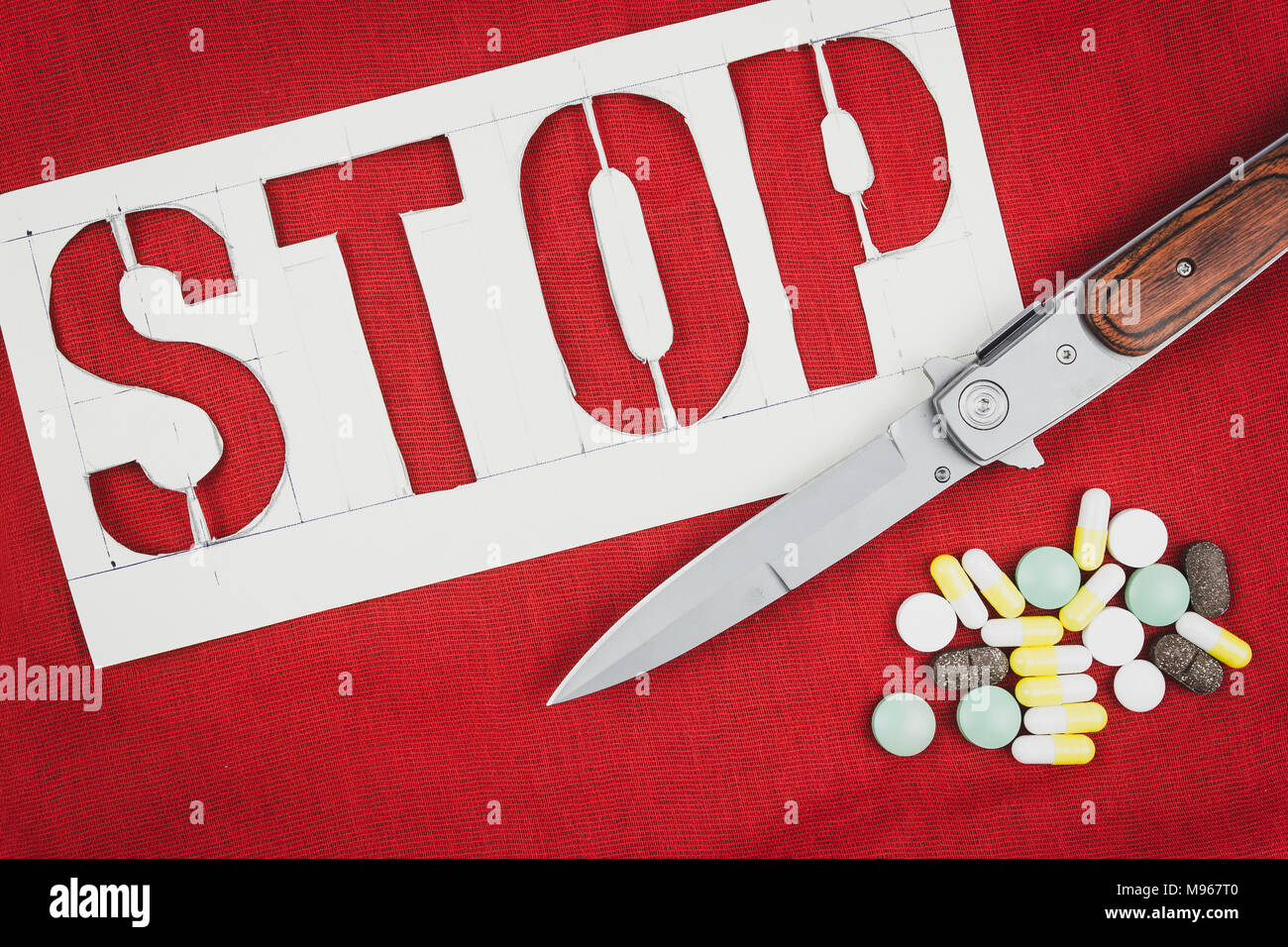 Kinfe Stop Sign A stop sign, the knife and pills on red background. The risk of crime ...