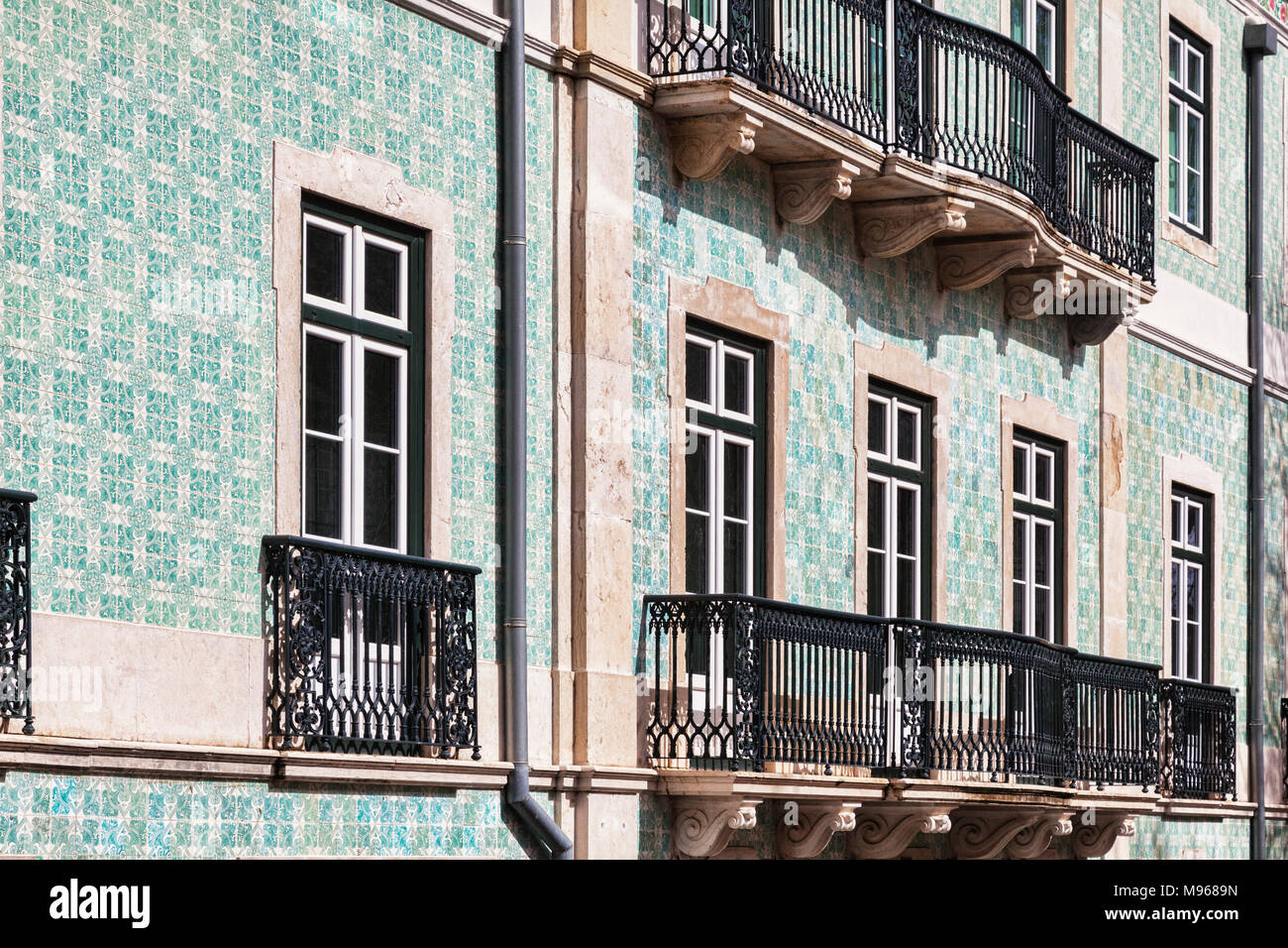 1 March 2018: Lisbon, Portugal - Building in the Old Town with typical ceramic tiled facade and wrought iron balconies. Stock Photo