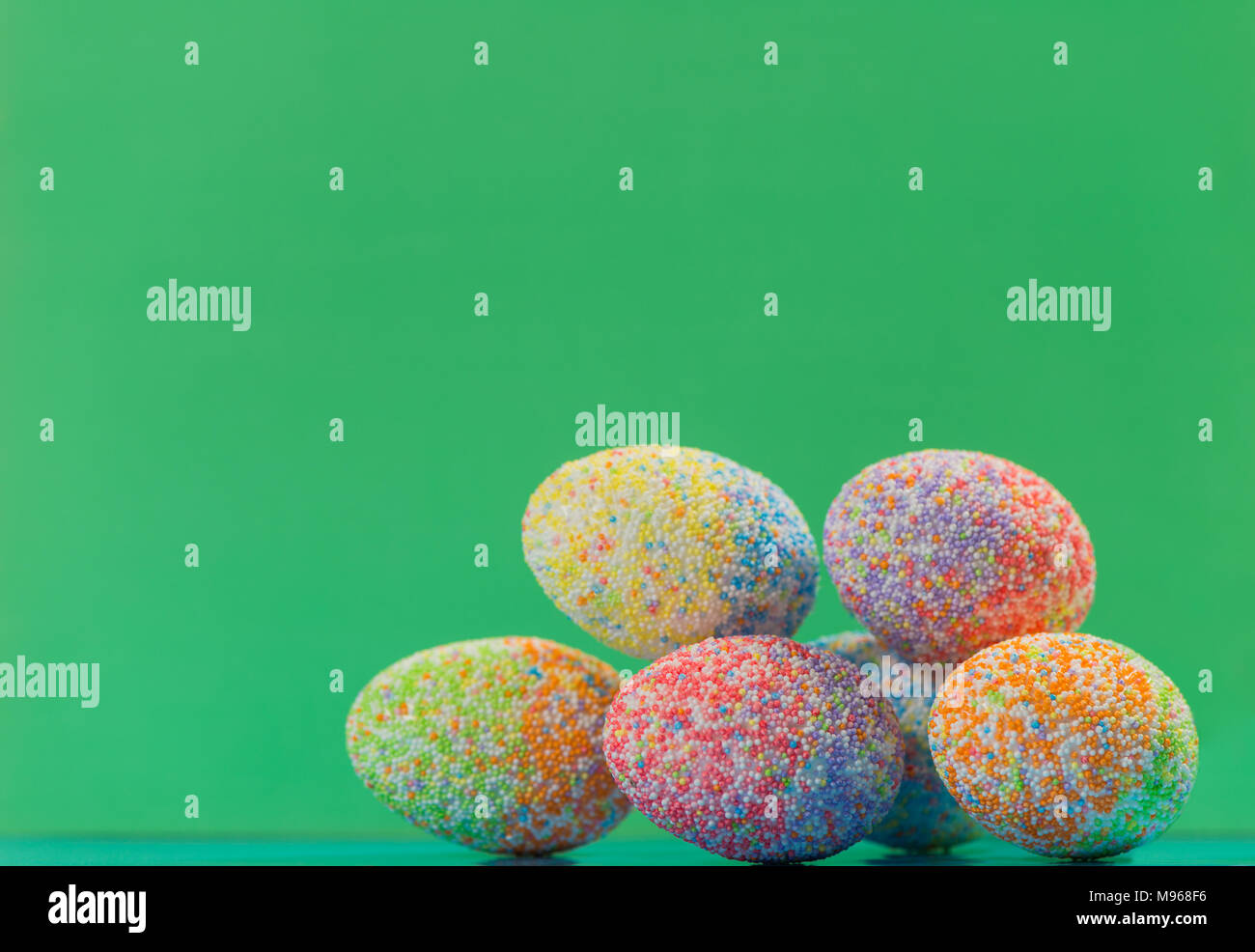 multicolor decorated easter eggs in line on colorful background Stock Photo