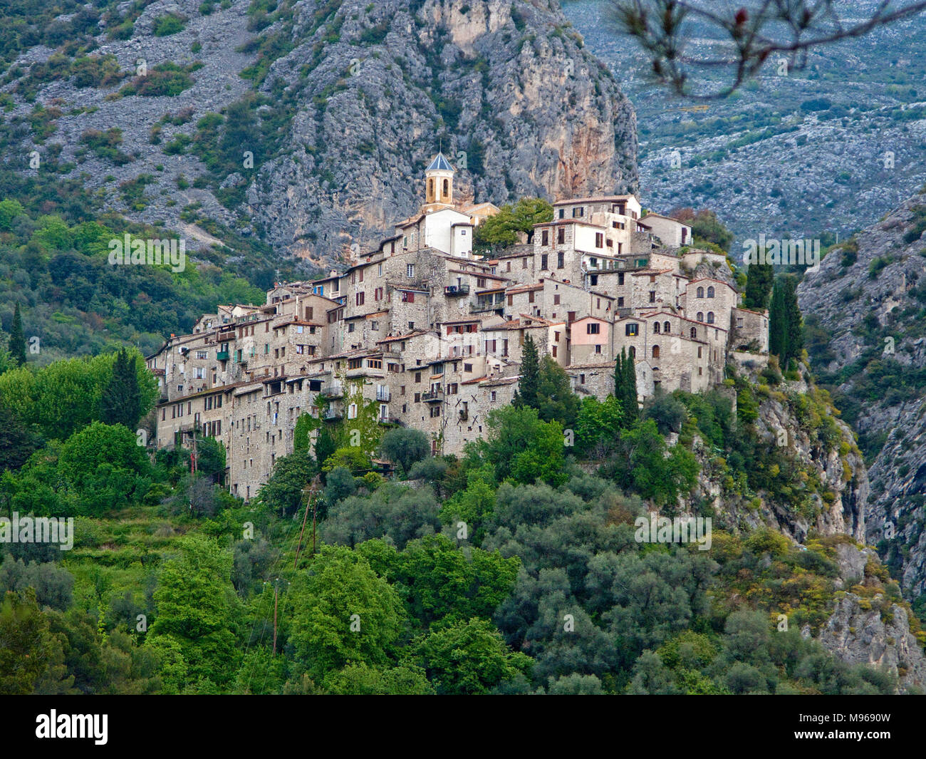 The fortified medieval village Peillon clings to a cliff face ...