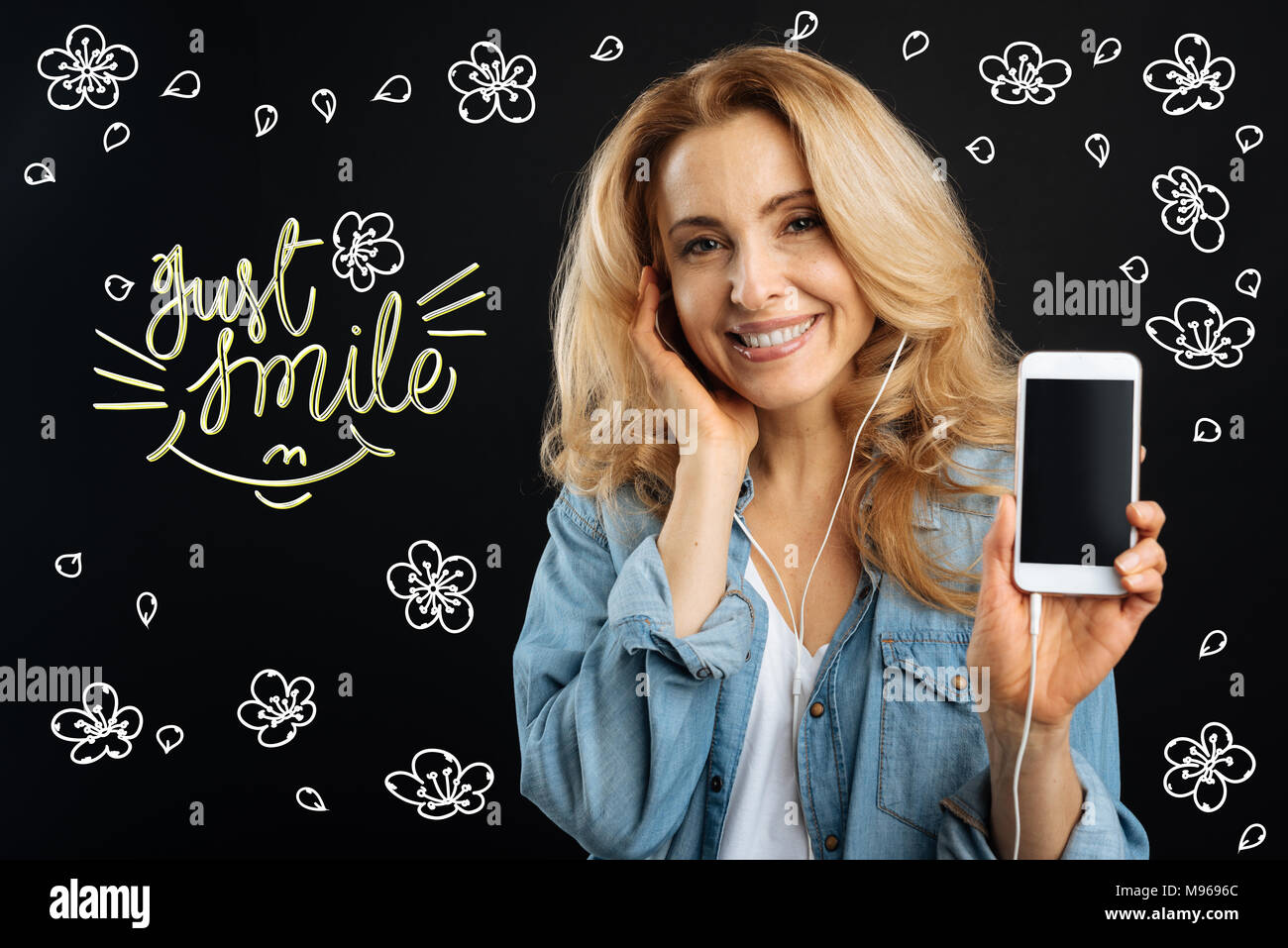 Cheerful woman smiling and showing her new convenient gadget Stock Photo