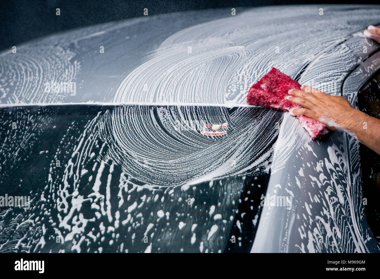 washing car using nano sponge with foam on a car wash Stock Photo