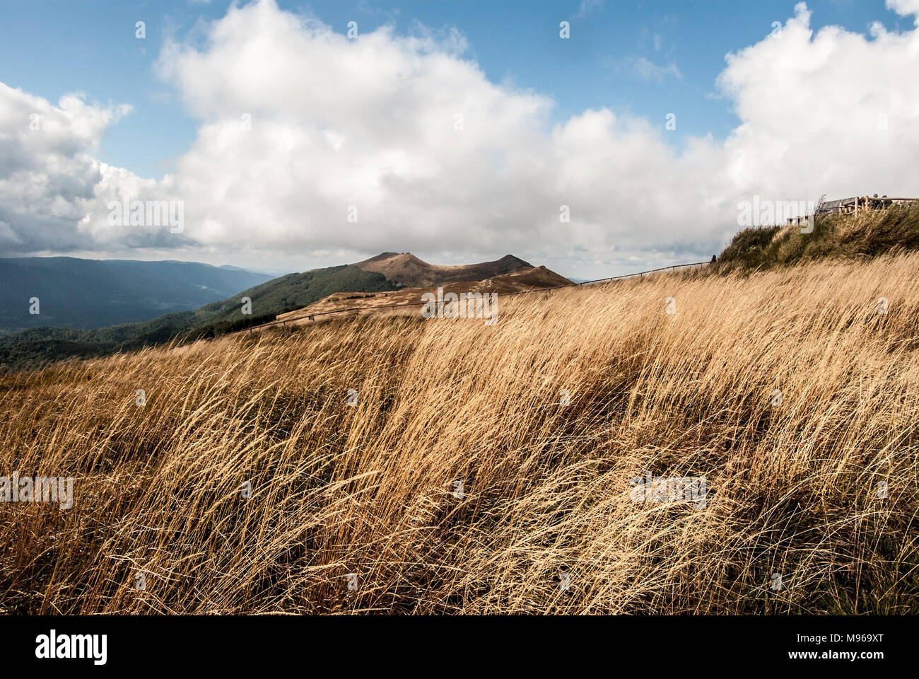 autumn Polonina Wetlinska from hiking trail near Chatka Puchatka in Bieszczady mountains in Poland with mountain meadow, hills and blue sky with cloud Stock Photo