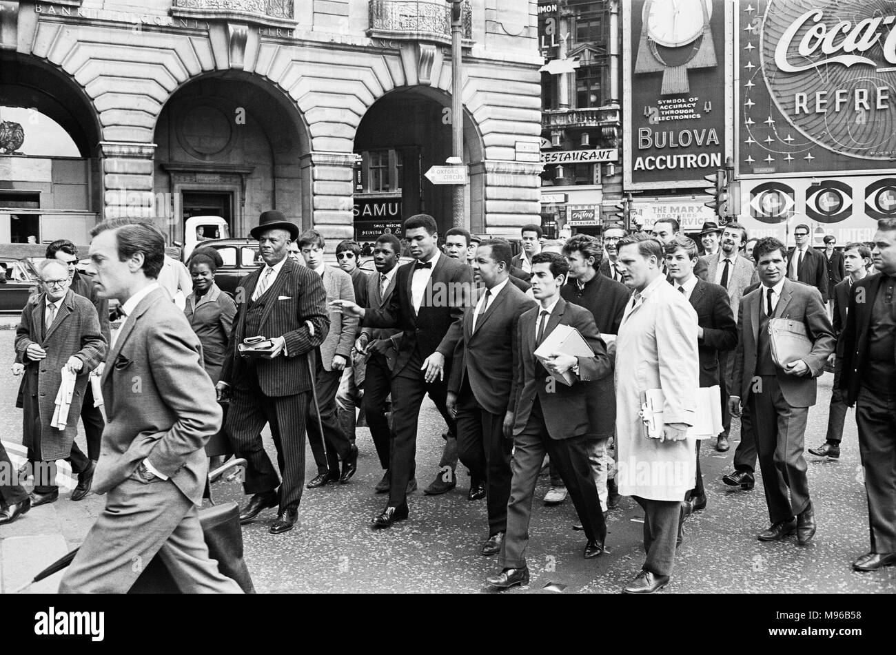 Cassius Clay and entourage walking through Regent Street on route to his press conference. 19th May 1966. Stock Photo
