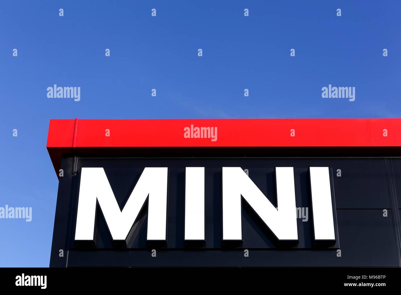 Villefranche sur Saone, France - September 27, 2015: Mini logo on a facade of a dealer. Mini is a British automotive marque owned by BMW Stock Photo