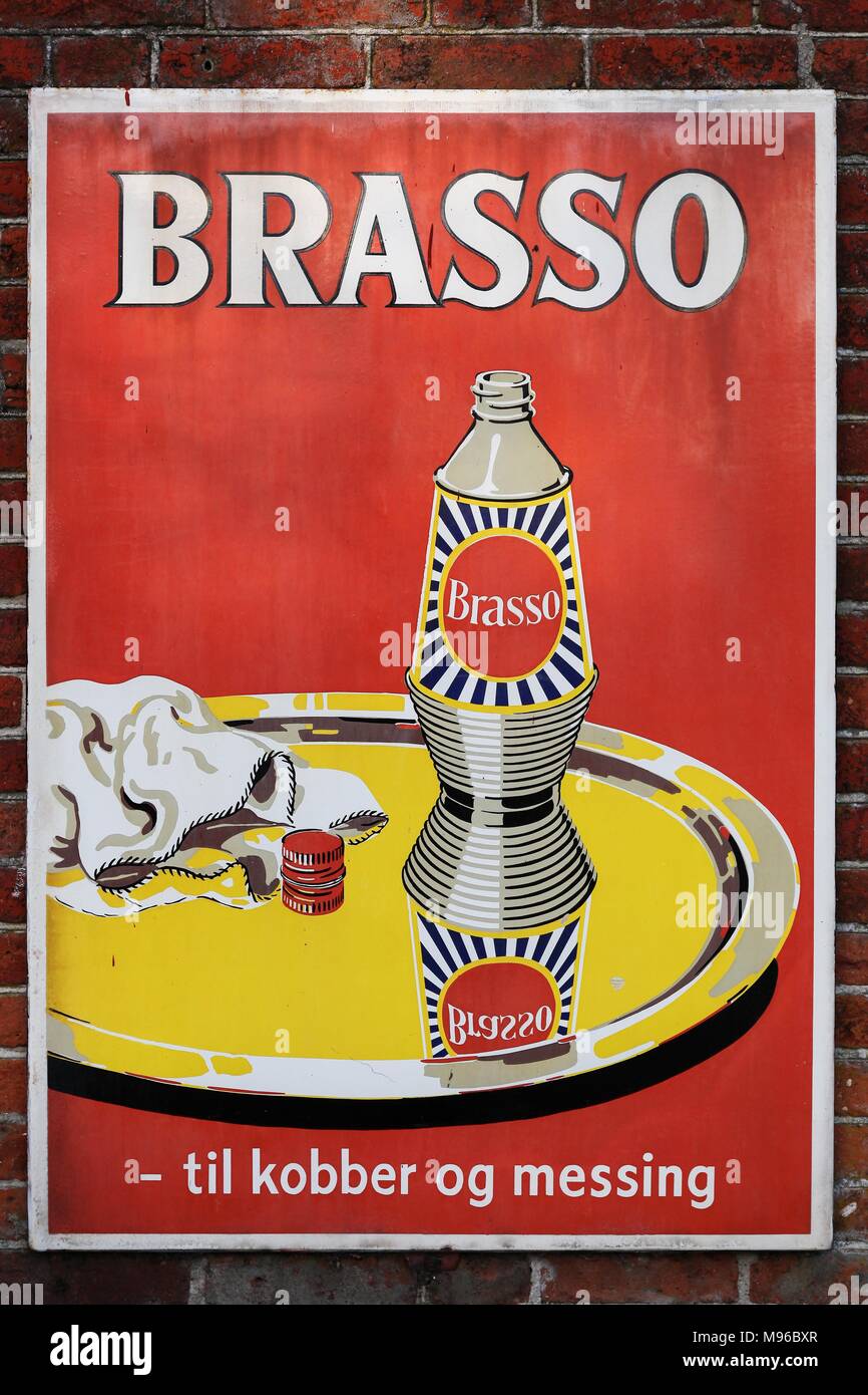 Vejle, Denmark - November 12, 2015: Old style tin advertising board for Brasso metal polish on a wall Stock Photo