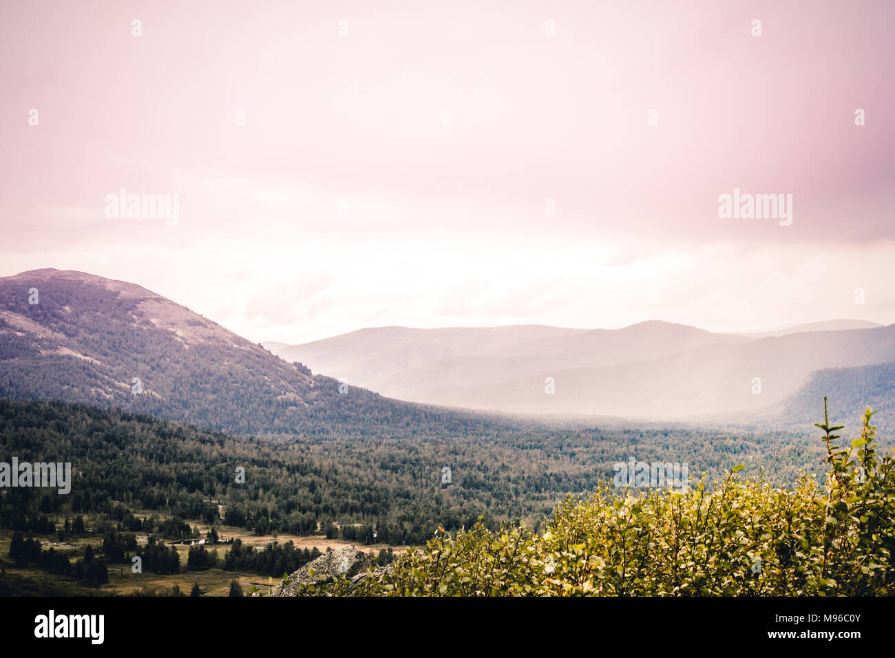Mountain country under the pastel pink sky. A romantic trip to the ...