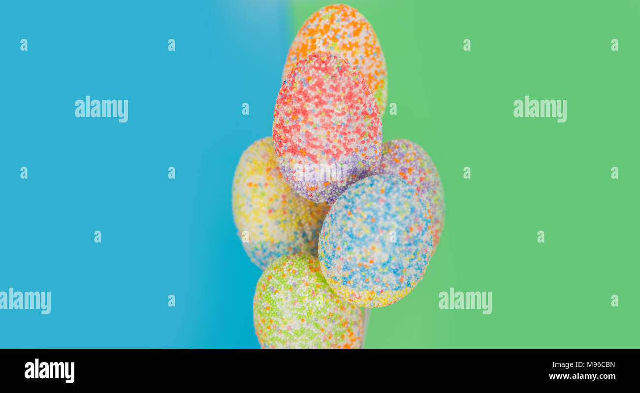 multicolor decorated easter eggs in line on colorful background Stock Photo