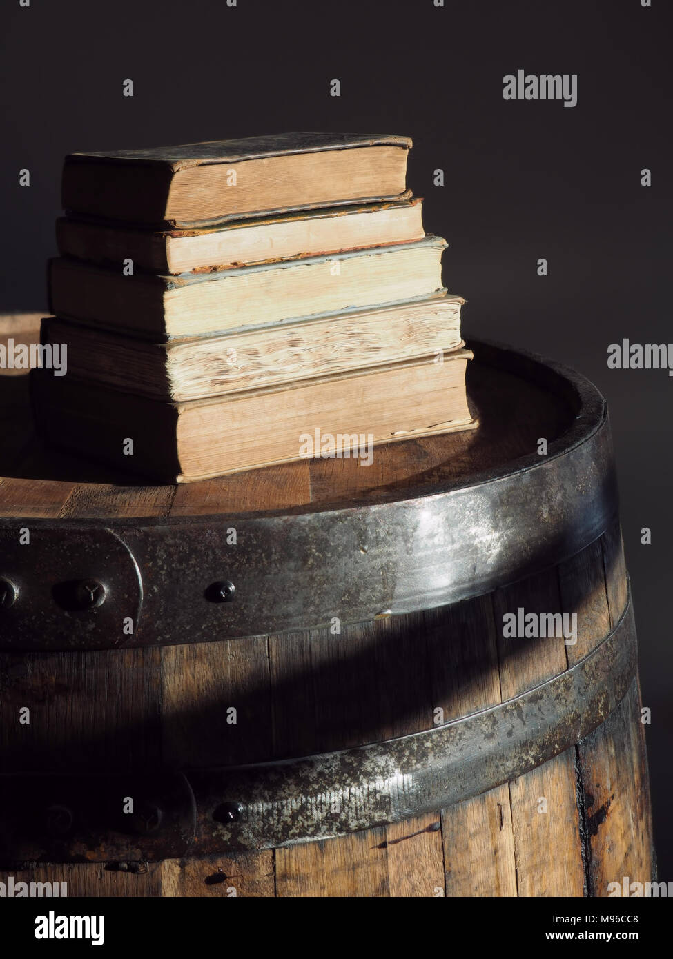 pile of old books on barrel Stock Photo
