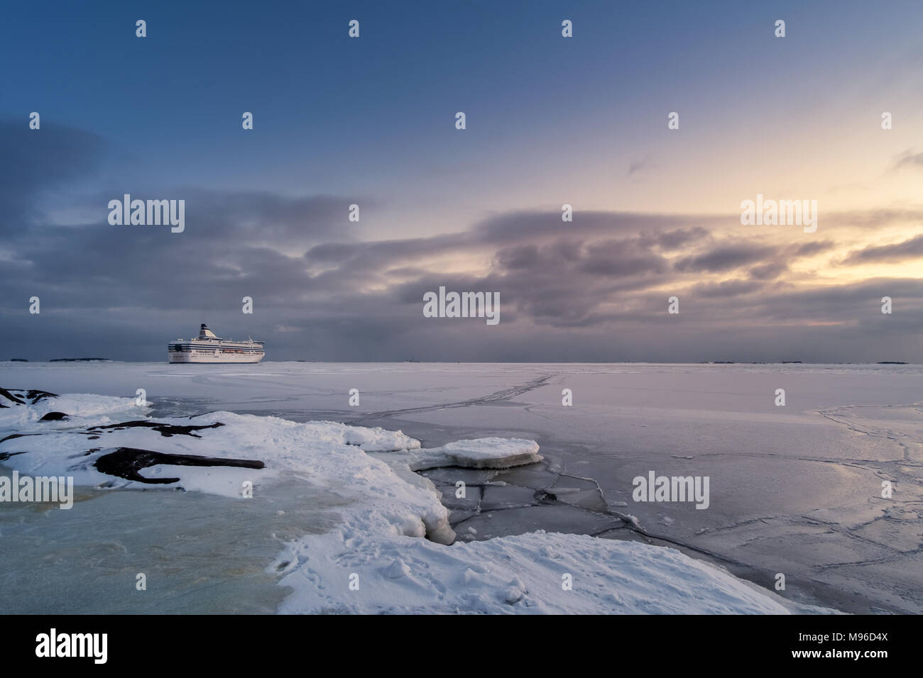 Scenic winter landscape with cruise and sunset at cold evening in Helsinki, Finland Stock Photo