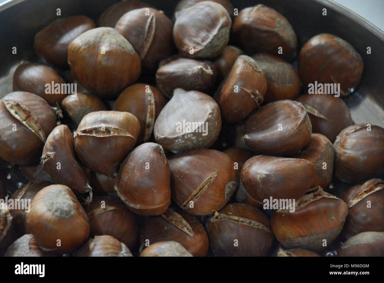 Roasting chestnuts in a pan, South Italy Stock Photo Alamy
