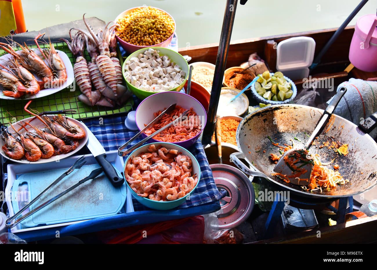 Preparing seafood in the street restaurant on boat in Thailand. Stock Photo