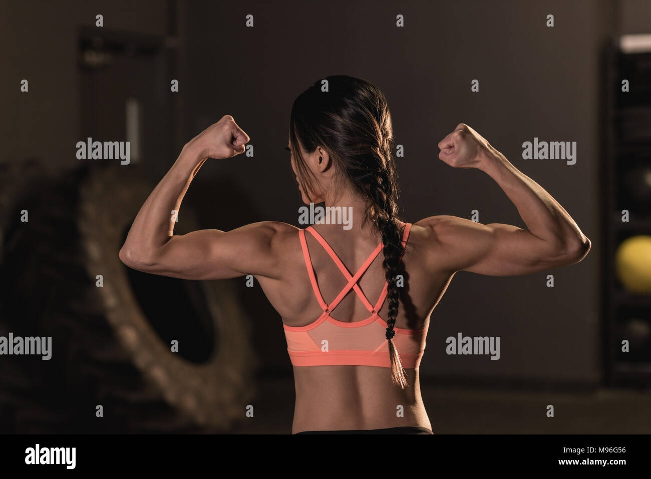 Rear view of fit woman flexing her muscles Stock Photo