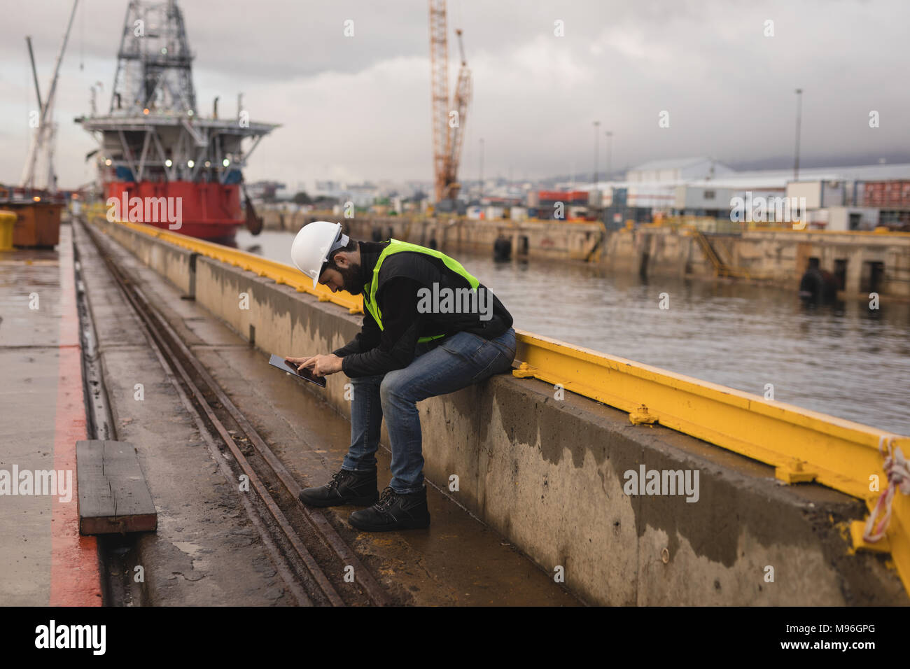 Dock worker using mobile phone Stock Photo