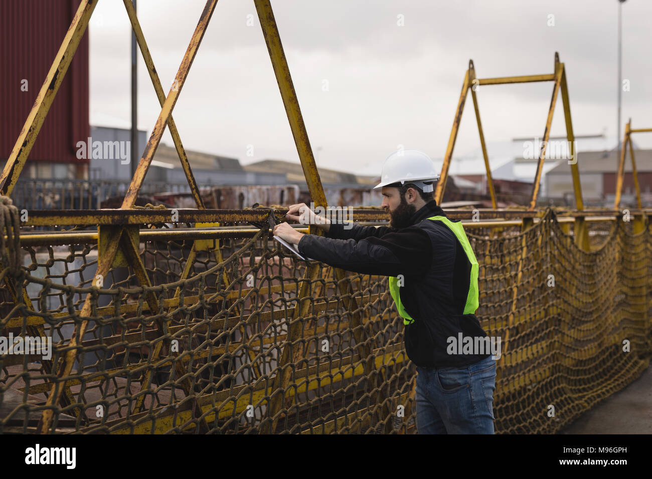 Dock worker adjusting net Stock Photo