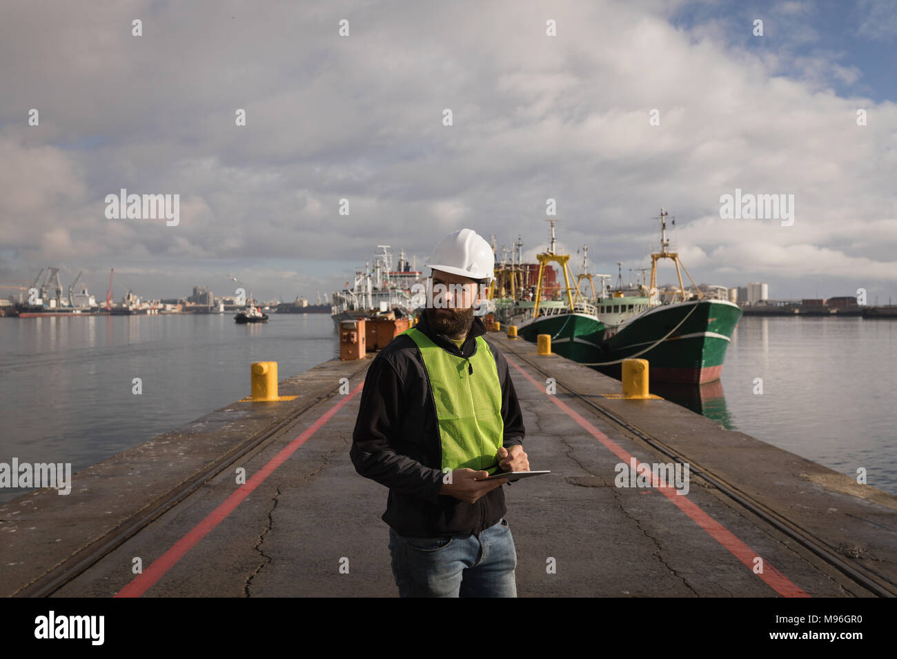 Dock worker using digital tablet Stock Photo