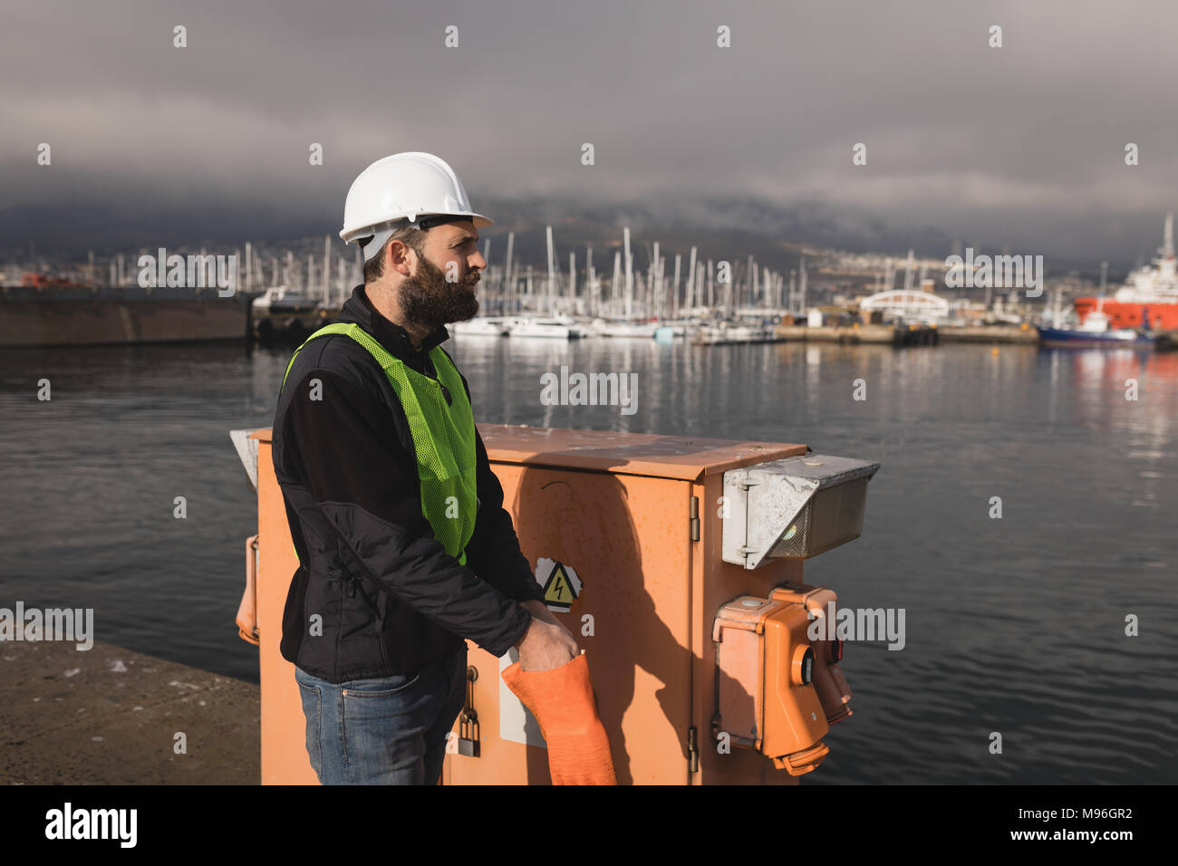 Dock worker wearing gloves in shipyard Stock Photo