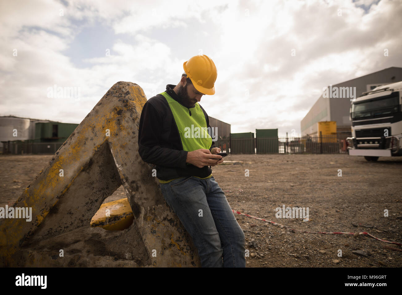 Dock worker using mobile phone Stock Photo