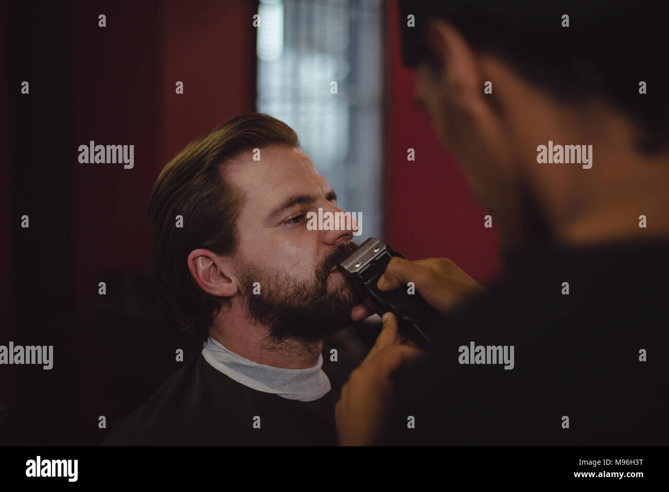 Man getting his beard trimmed with trimmer Stock Photo