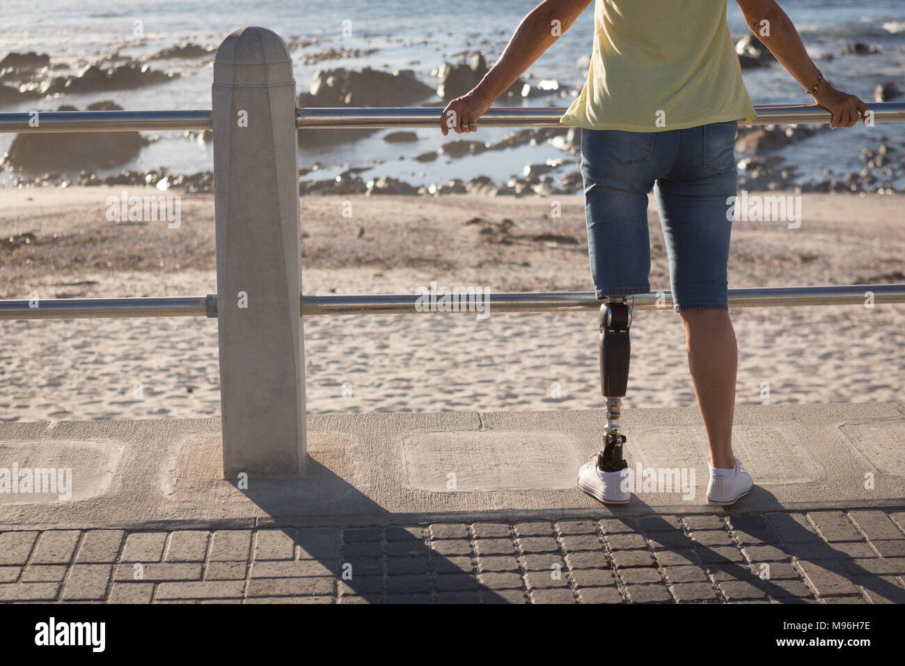 Disabled woman standing near beach Stock Photo