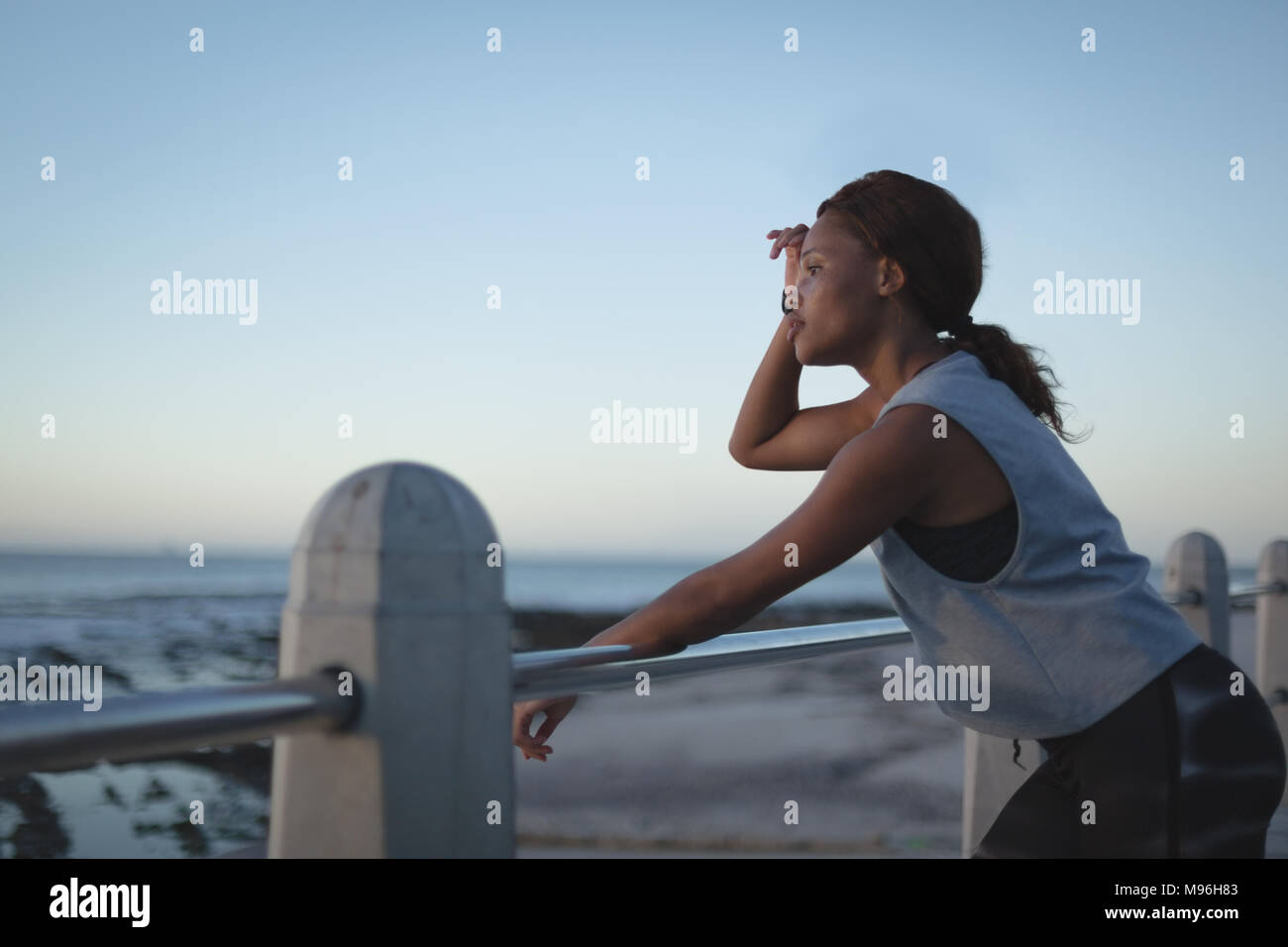 Tired woman standing near beach Stock Photo