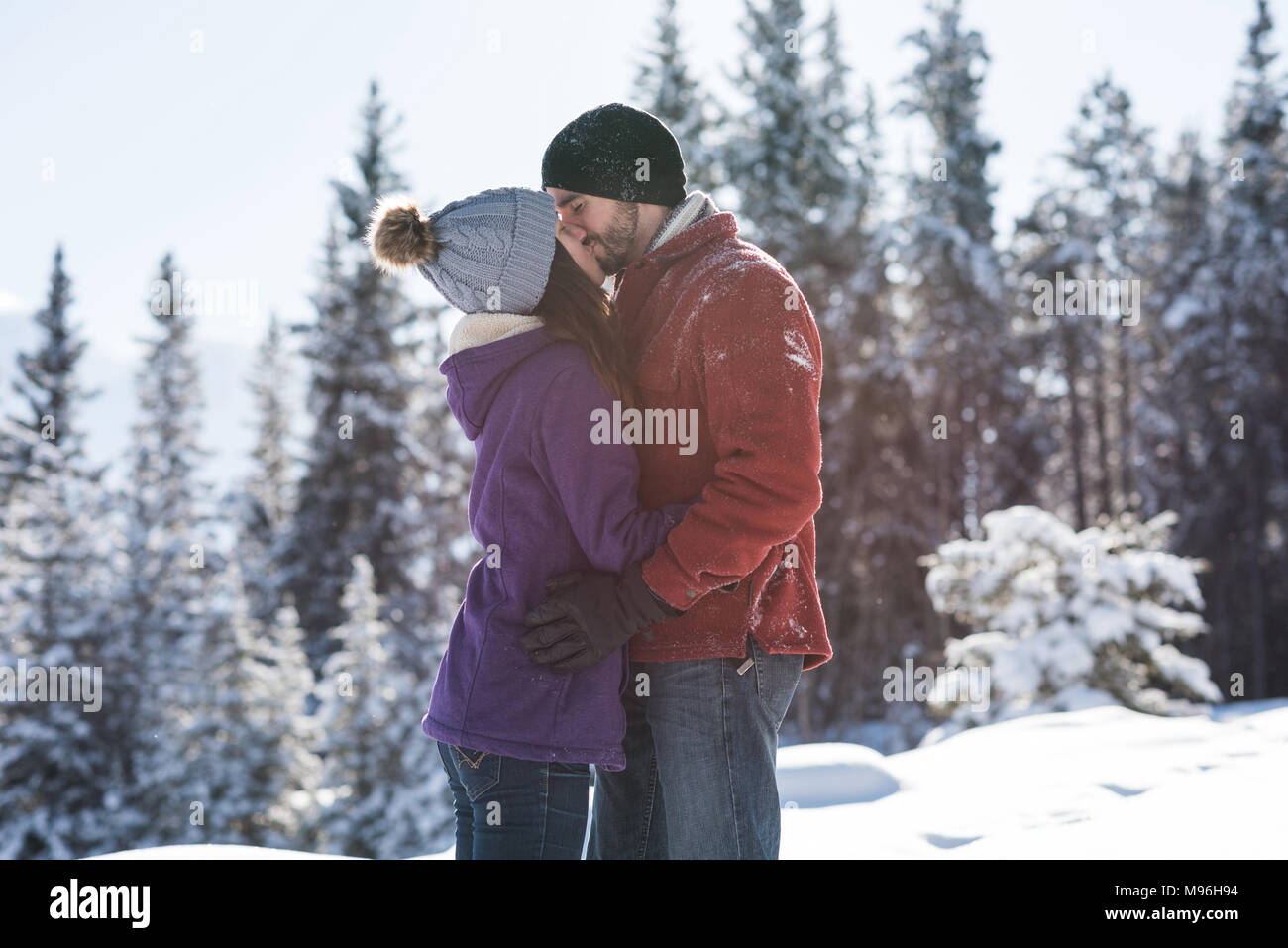Couple kissing each other in snowy landscape Stock Photo