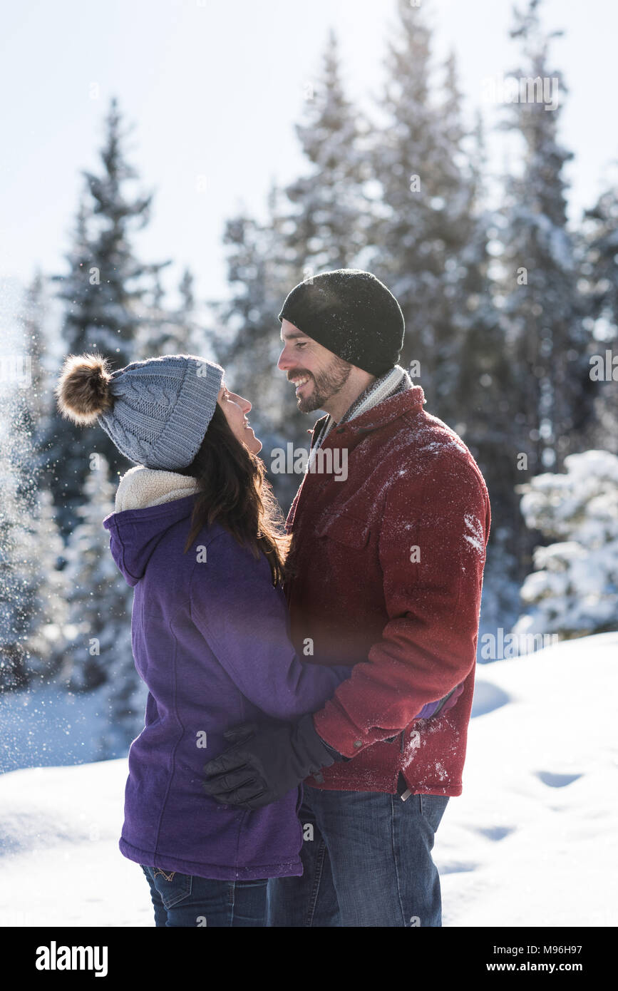 Couple embracing each other in snowy landscape Stock Photo