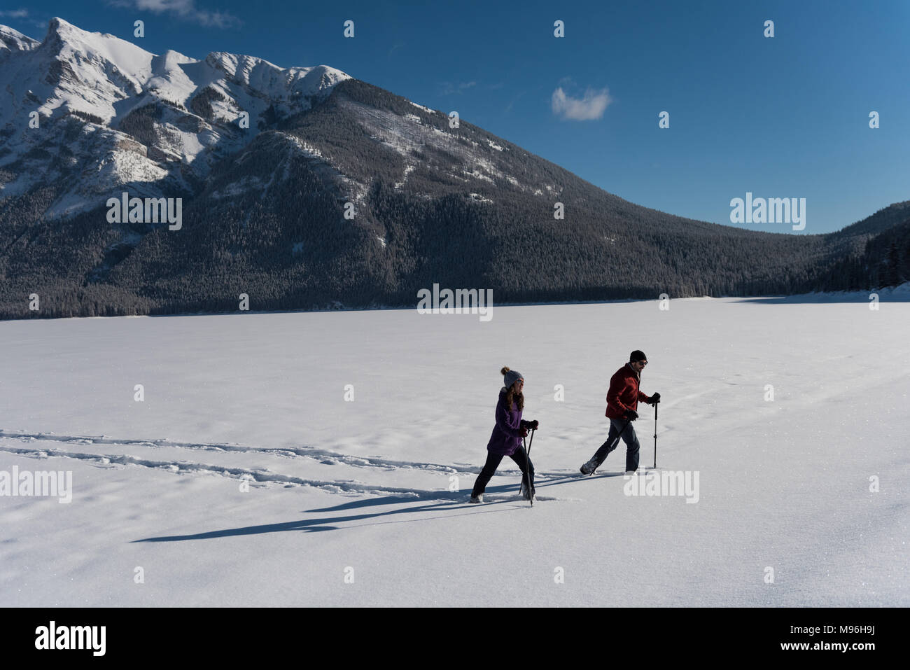 Couple walking together in snowy landscape Stock Photo