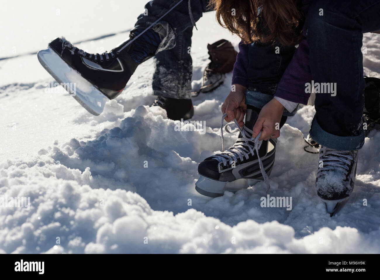 Couple wearing snow skate in snowy landscape Stock Photo