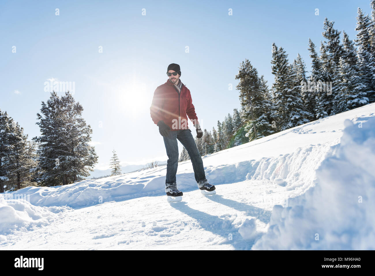 Man skating in snowy landscape Stock Photo