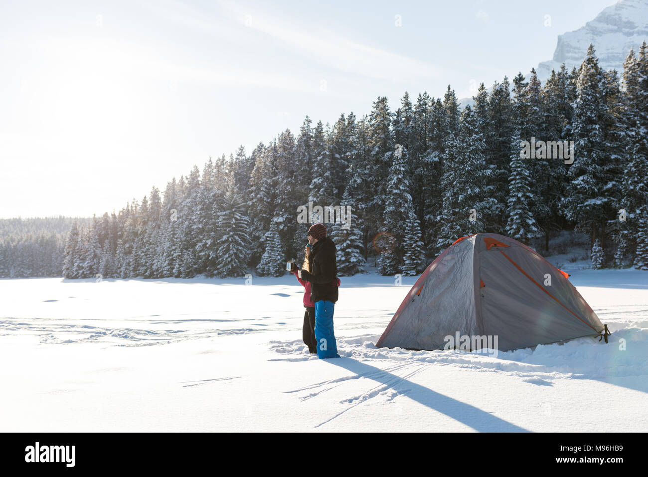 Couple standing together in snowy landscape Stock Photo