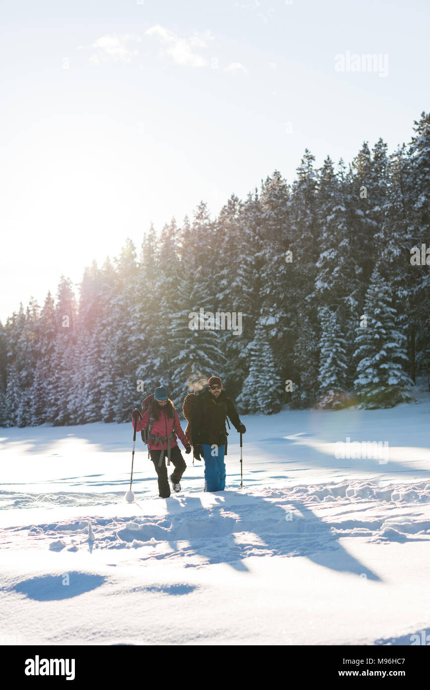 Couple walking together in snowy landscape Stock Photo