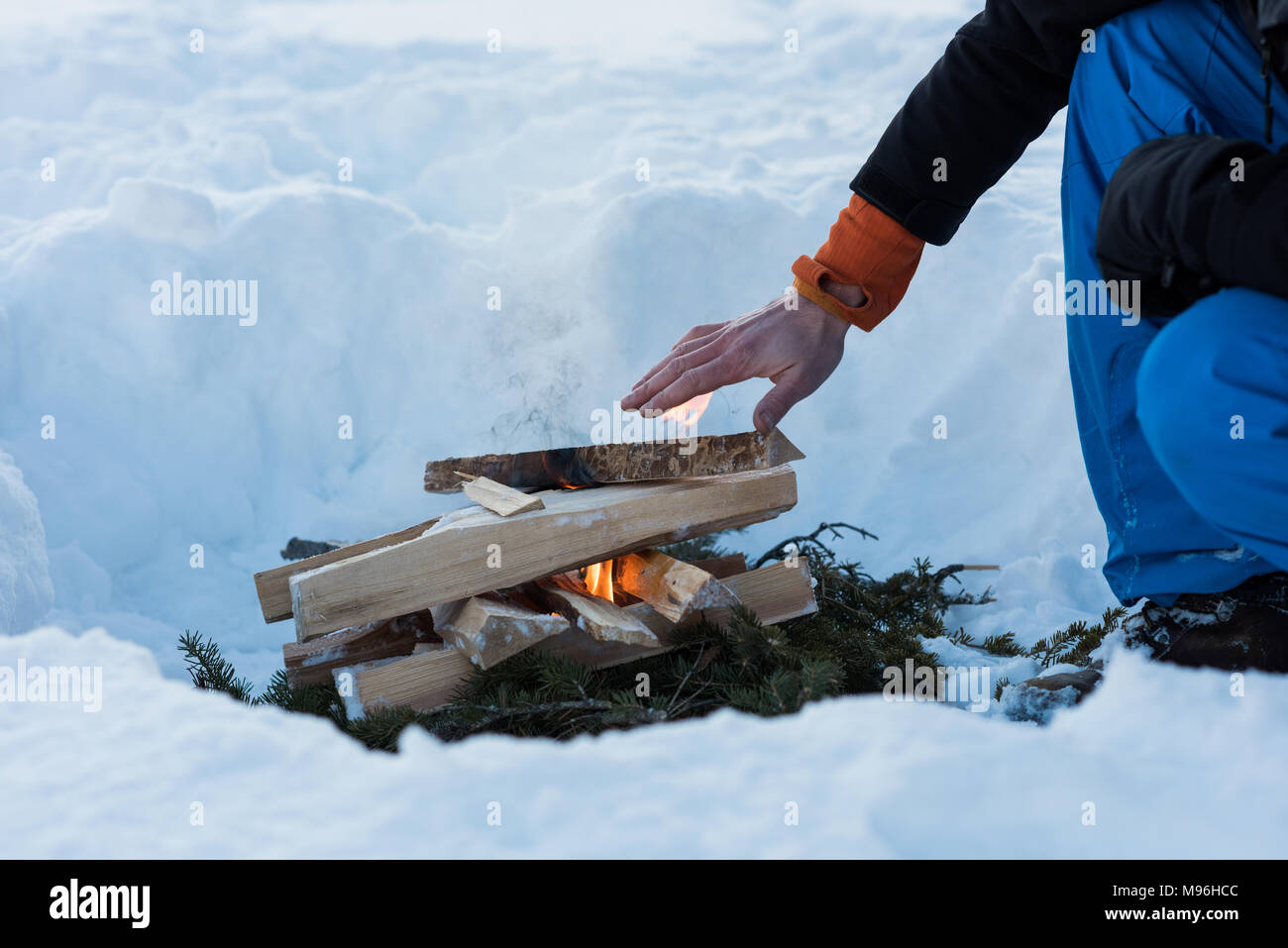 Man warming up by the bonfire during winter Stock Photo