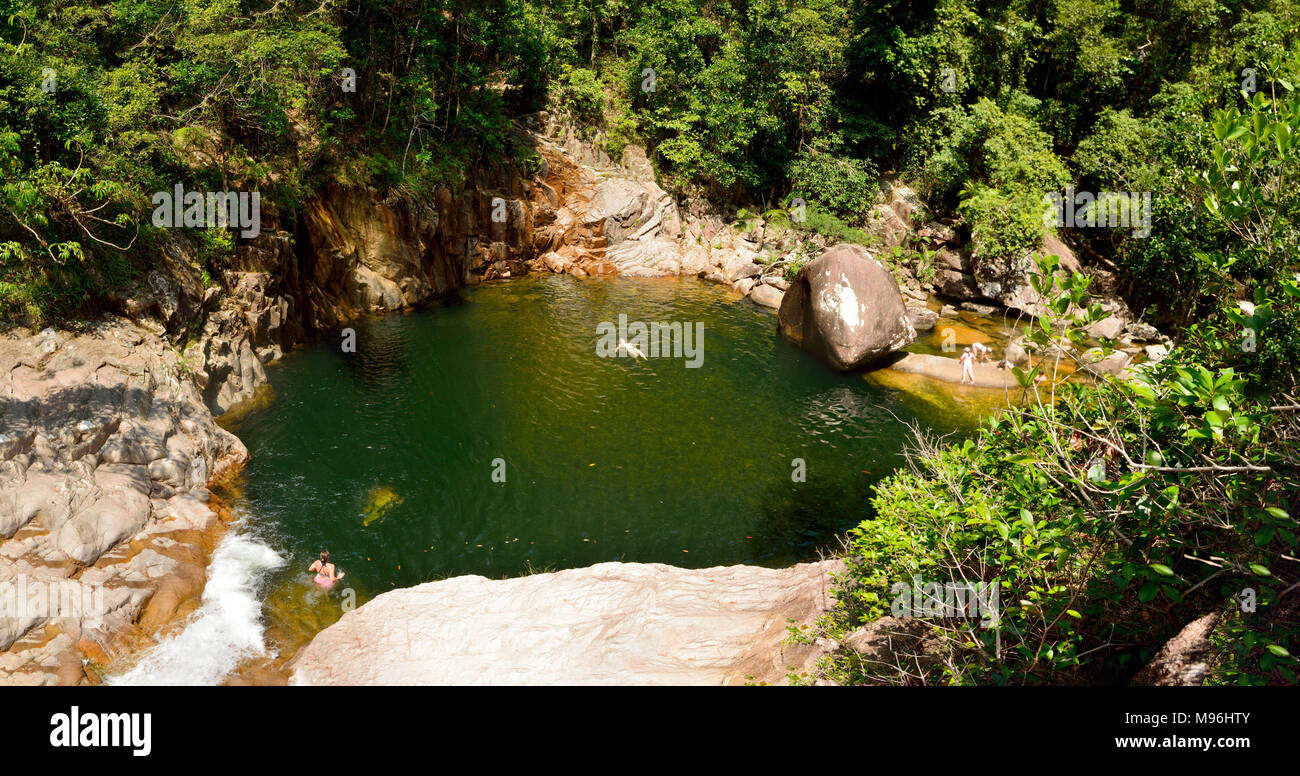 View of swimming hole at Wheel of Fire falls in Eungella National Park in Queensland, Australia, with unidentifiable figures of people. Stock Photo