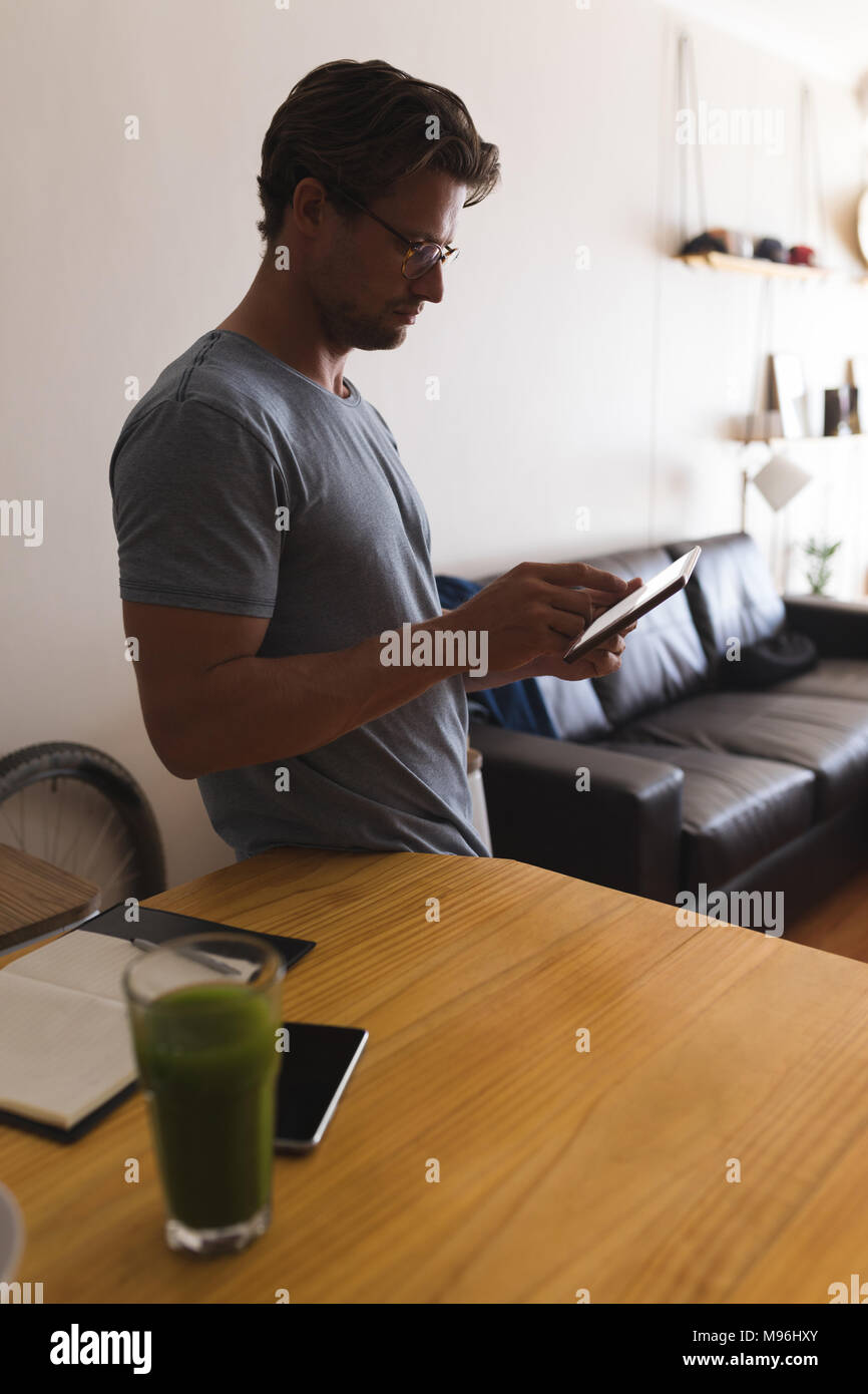 Man using mobile phone in living room Stock Photo