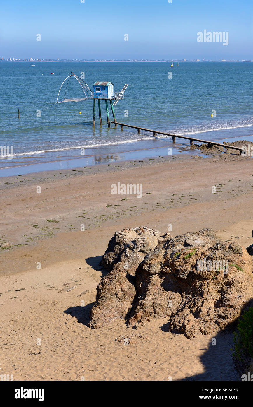 Fishing carrelets from Saint-Michel-Chef-Chef at low tide and the town of Saint Nazaire in the background in Pays de la Loire region in western France Stock Photo