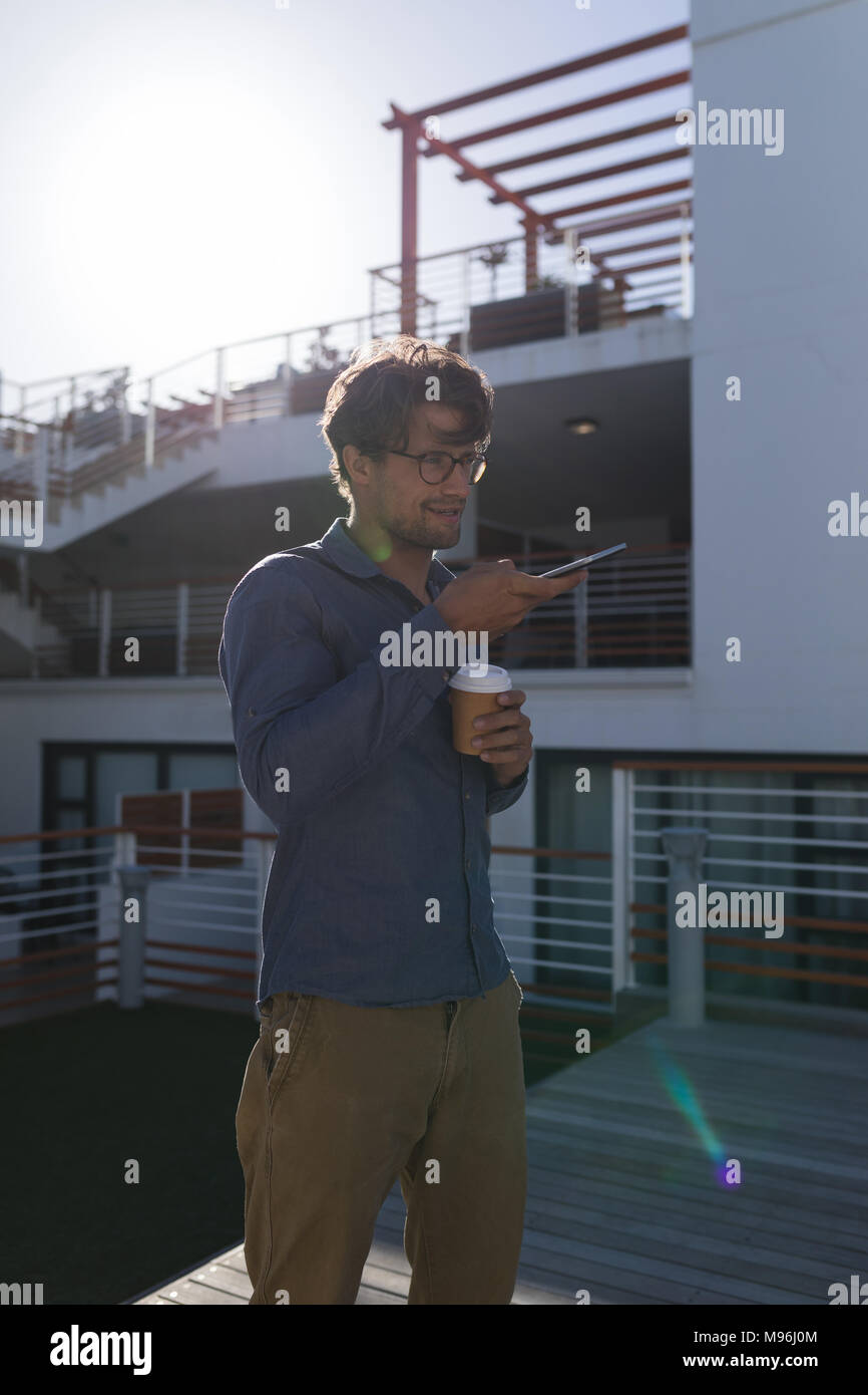 Man talking on mobile phone in the balcony Stock Photo