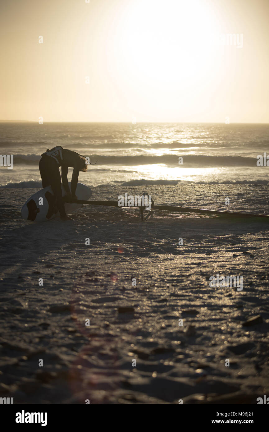 Male surfer preparing a kite on a beach Stock Photo