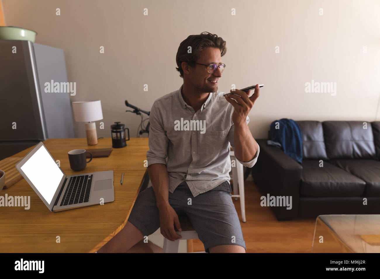 Man talking on mobile phone at home Stock Photo