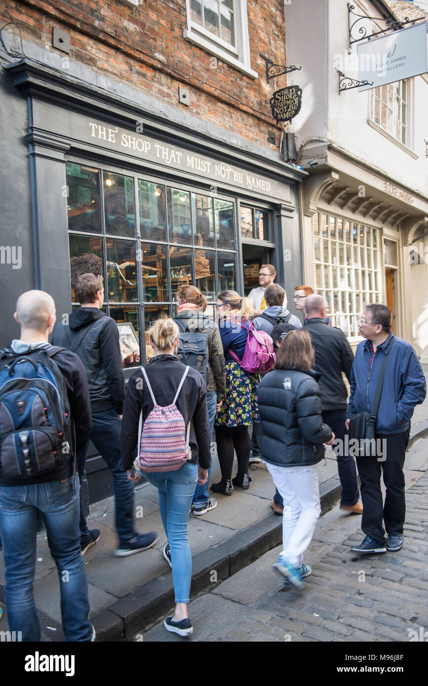 People queuing for afternoon tea outside Bettys Cafe and Tea Room St Helen's Square York UK Stock Photo