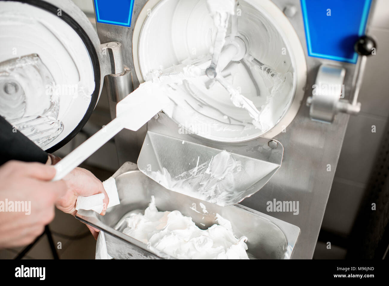 Cleaning ice cream maker machine from the ice cream leavings Stock Photo