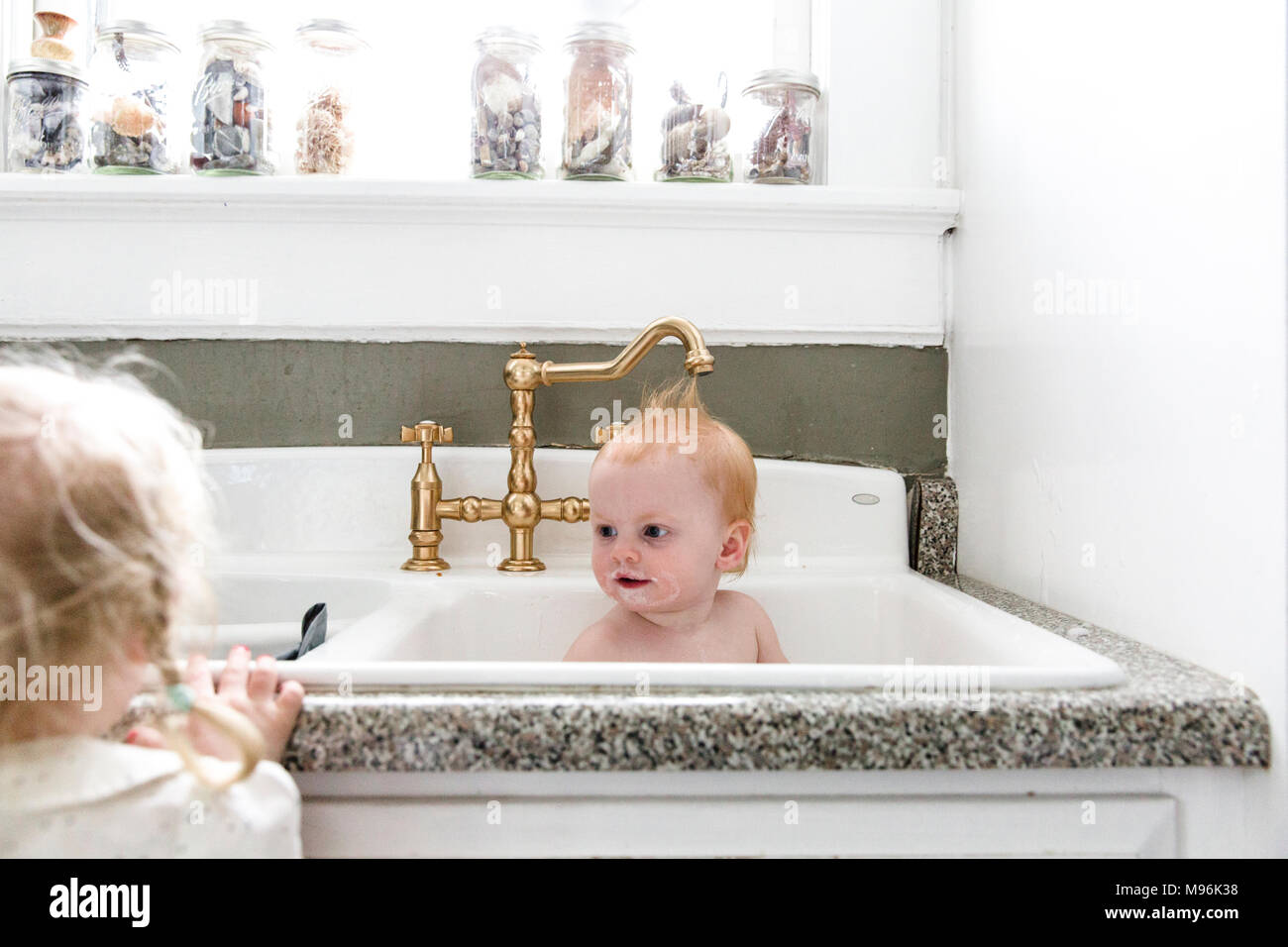 Baby having bath in sink Stock Photo Alamy
