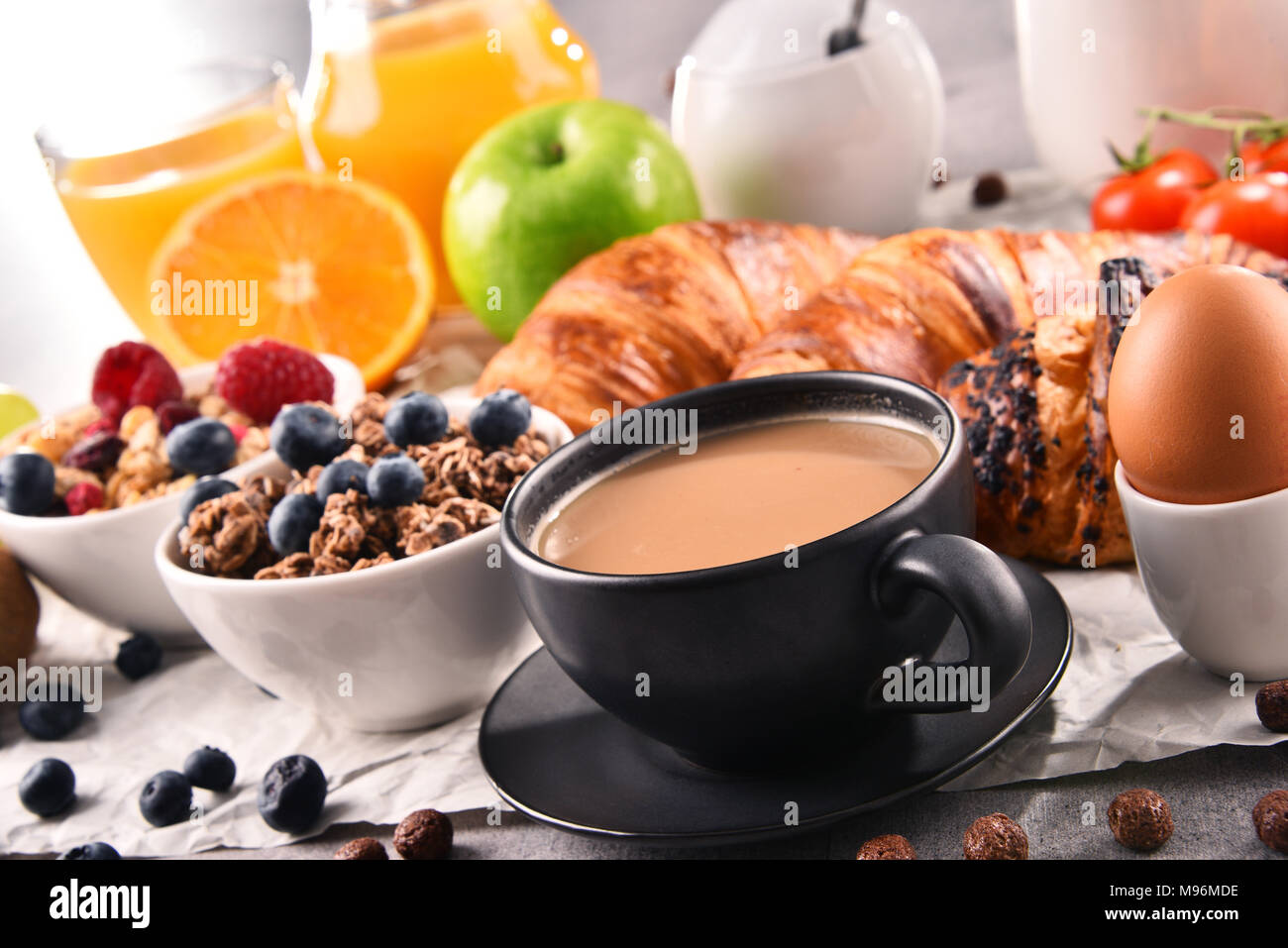 Breakfast served with coffee, orange juice, croissants, egg, cereals ...