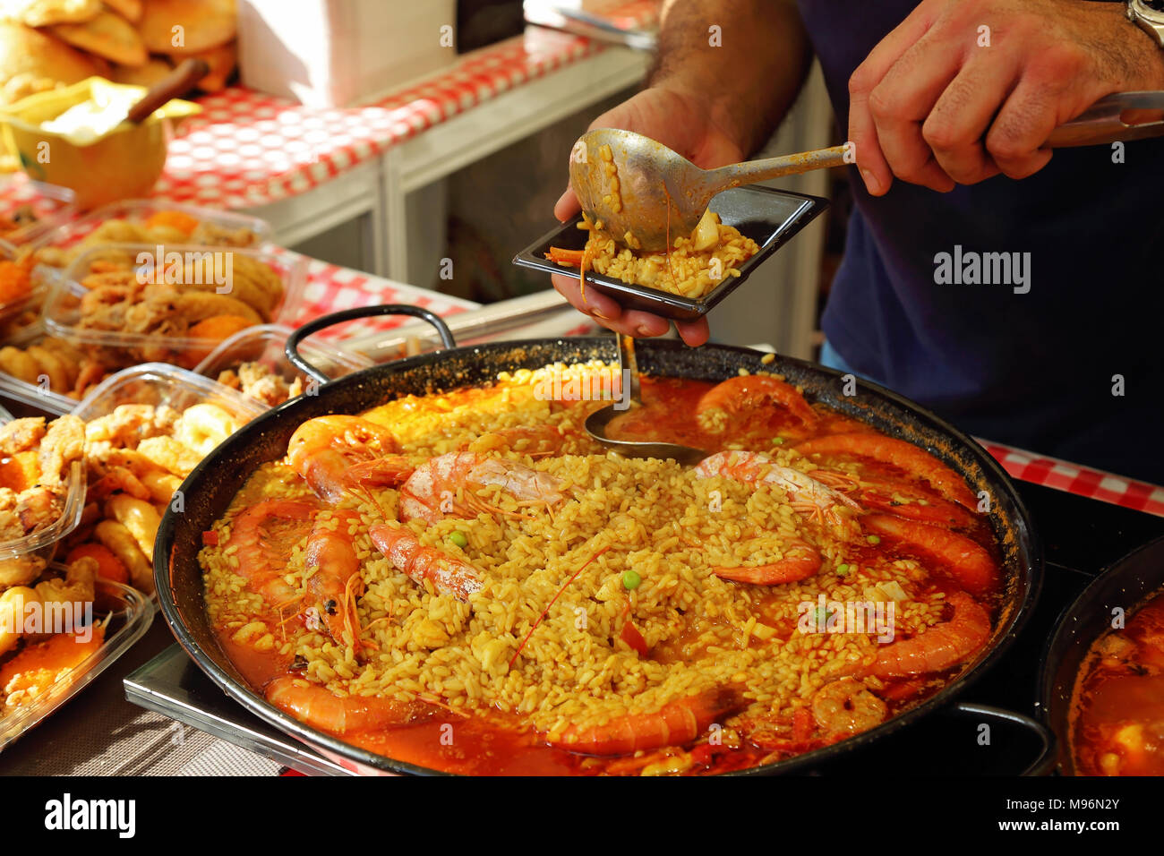 Paella preparation street market stand near Barcelona Cathedral