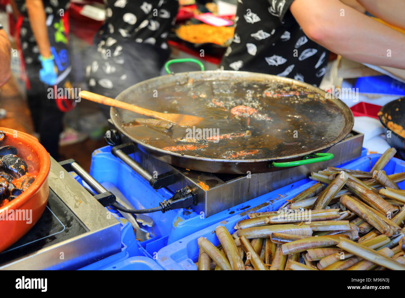 Paella preparation street market stand near Barcelona Cathedral