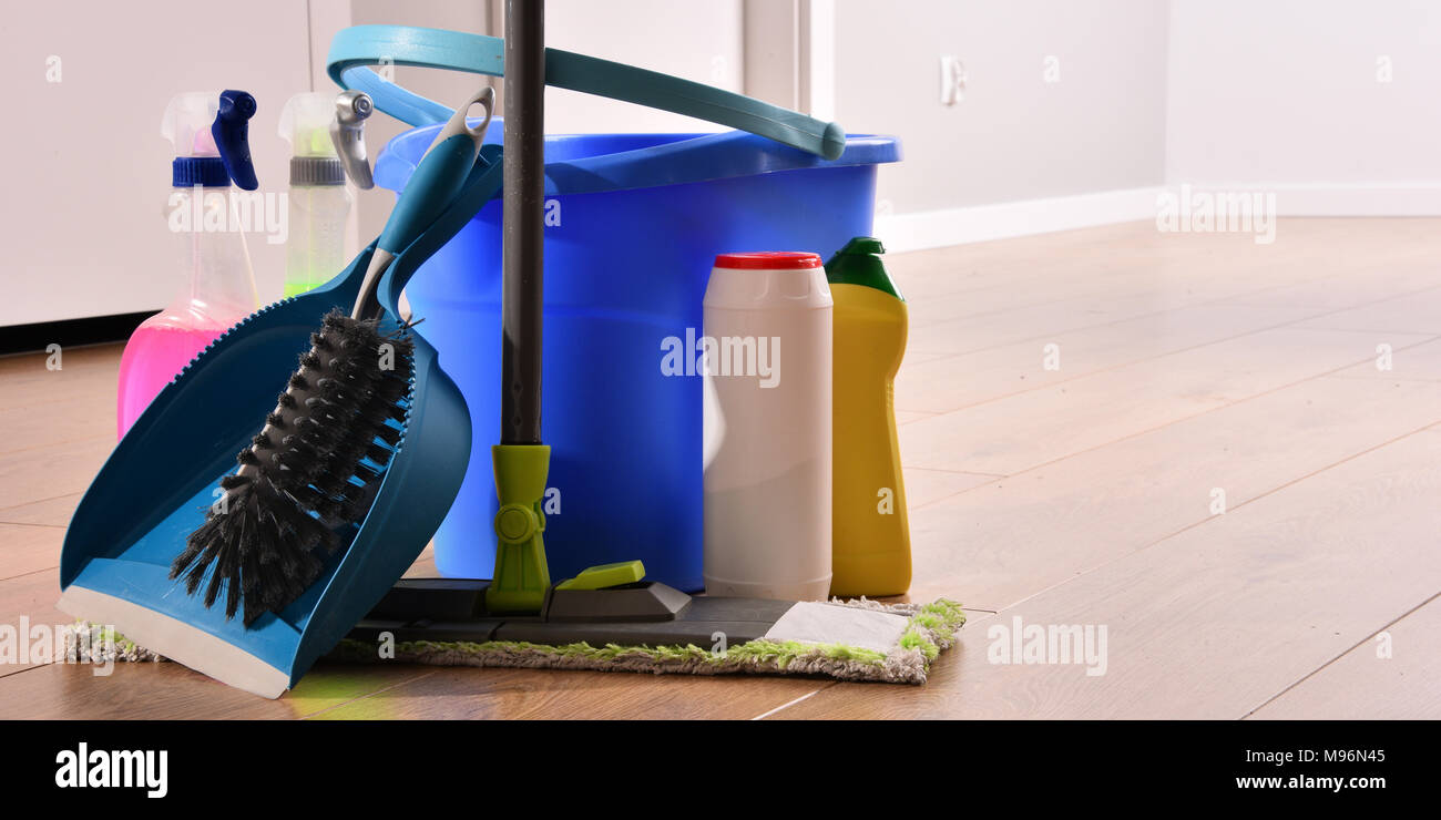 Variety of detergent bottles and chemical cleaning supplies on the floor Stock Photo