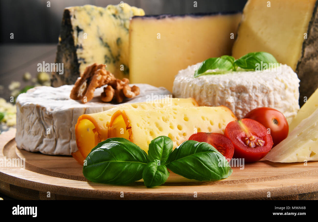 Different sorts of cheese on kitchen table Stock Photo - Alamy