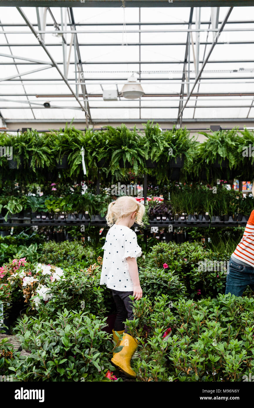 Girl in and around greenhouse within Garden Center Stock Photo - Alamy