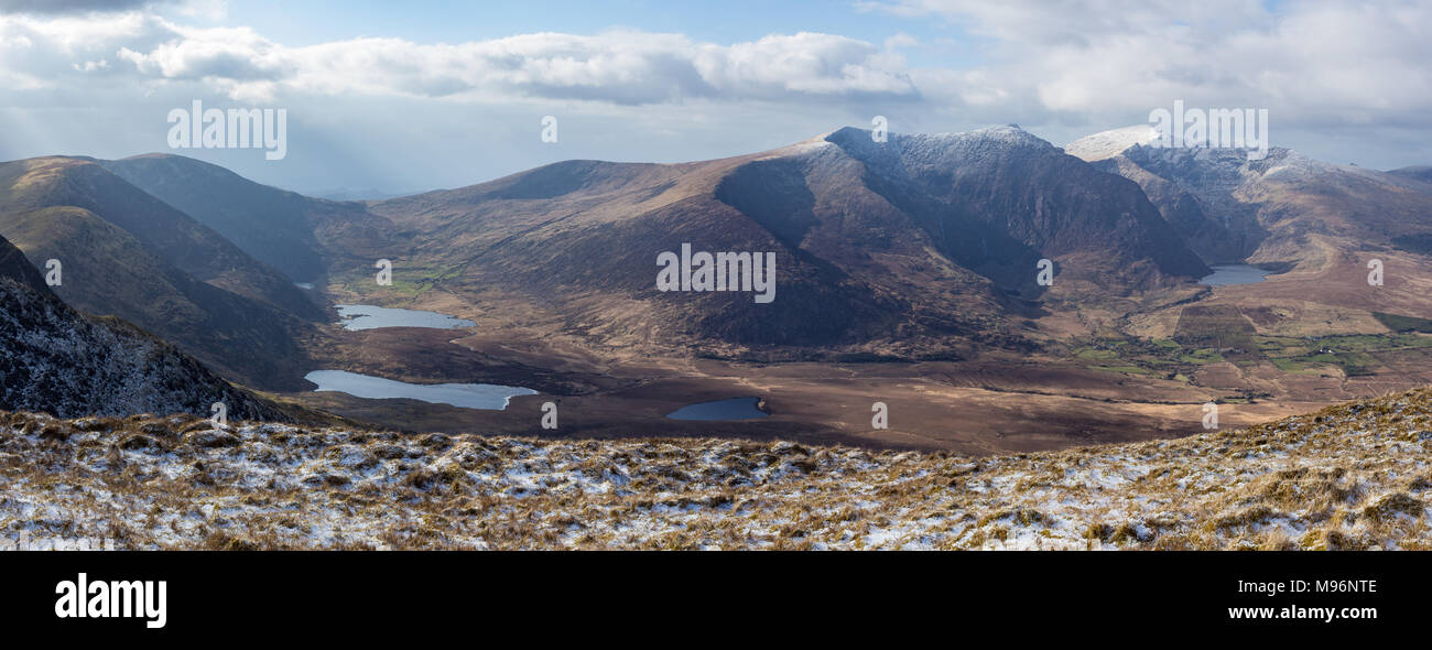 Panoramic view of mountain range on the Dingle Peninsula in County Kerry, Ireland showing Brandon Peak and Mount Brandon with snow Stock Photo