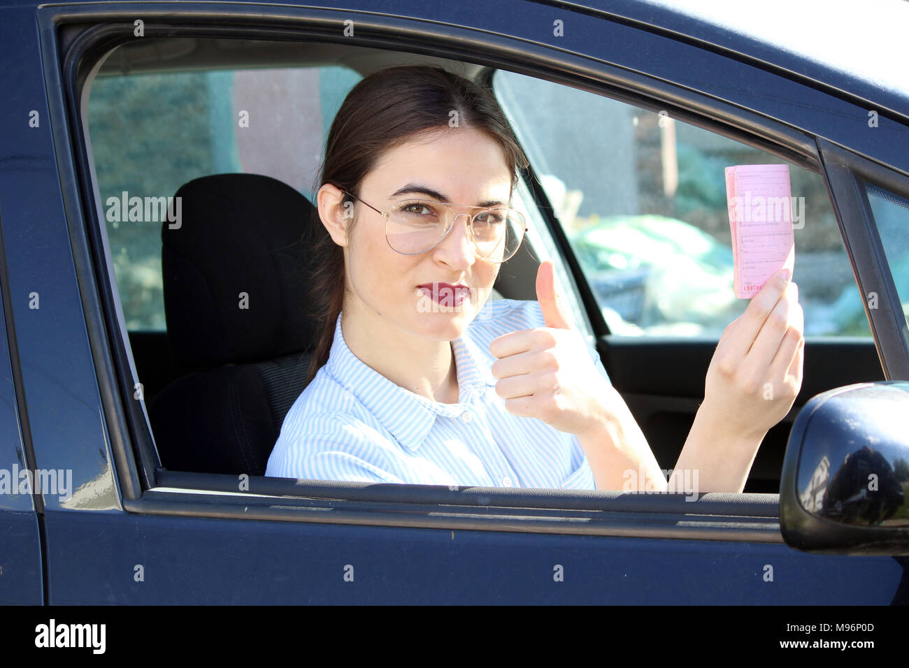young driver showing driving licence Stock Photo